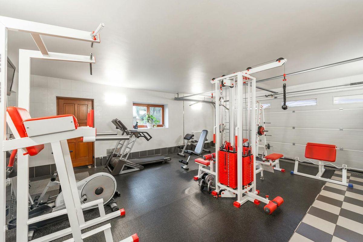 Spacious gym interior with steel blue accents and minimalist equipment